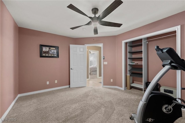 exercise room with light carpet and ceiling fan