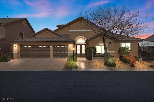 view of front of property with a garage and french doors