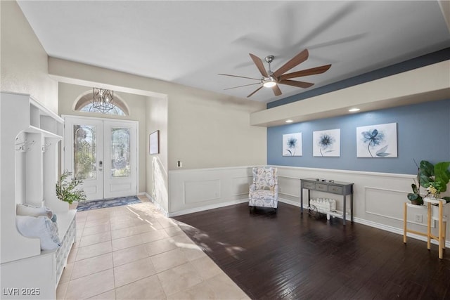 entrance foyer with ceiling fan, light hardwood / wood-style flooring, and french doors