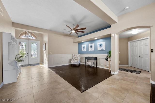 tiled entrance foyer featuring ceiling fan and french doors