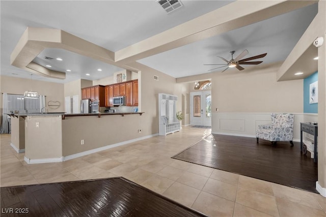 interior space featuring ceiling fan and light tile patterned flooring