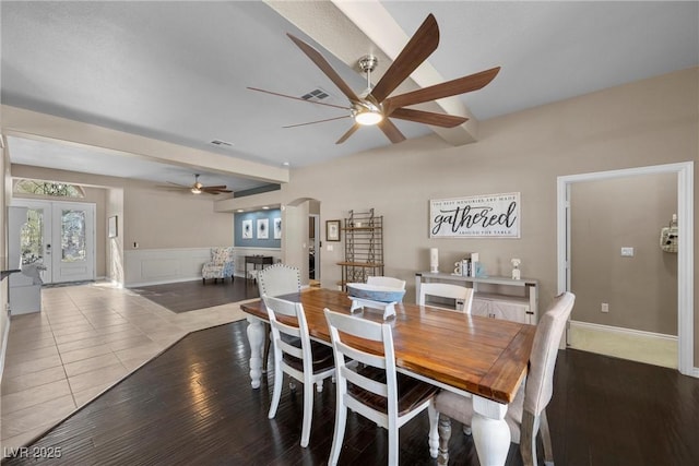 tiled dining area featuring ceiling fan, beam ceiling, and french doors