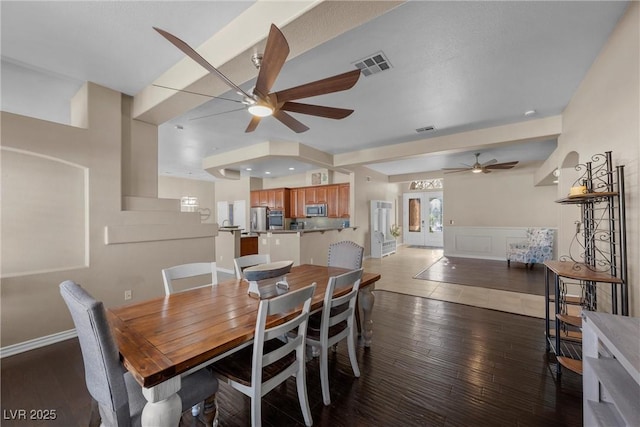 dining room with ceiling fan and dark wood-type flooring