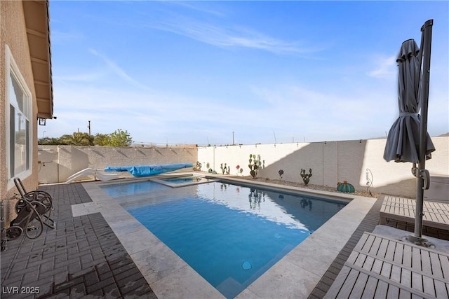 view of swimming pool with an in ground hot tub