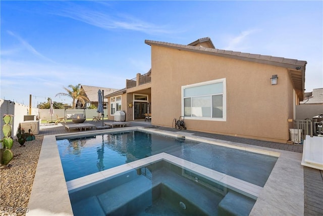 view of swimming pool featuring an in ground hot tub