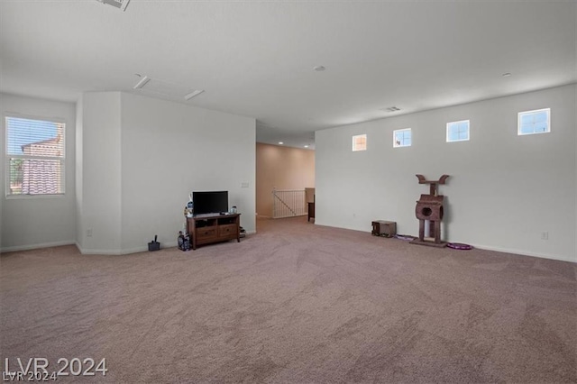 basement with light carpet and plenty of natural light