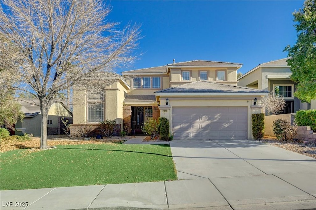 view of front of house featuring a front yard and a garage