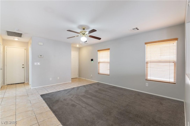 tiled empty room with ceiling fan