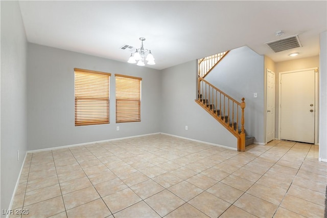 empty room featuring light tile patterned floors and an inviting chandelier