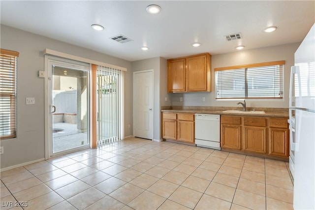 kitchen with white appliances, sink, and light tile patterned floors