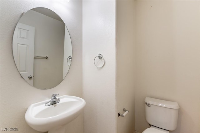 bathroom featuring sink and toilet