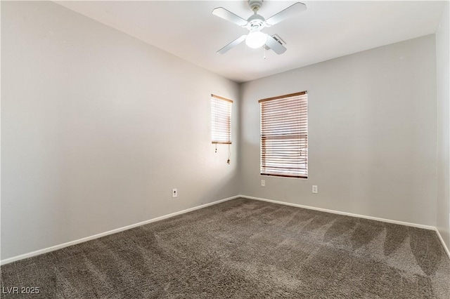 carpeted spare room featuring ceiling fan