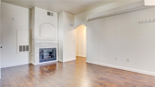 unfurnished living room featuring hardwood / wood-style flooring