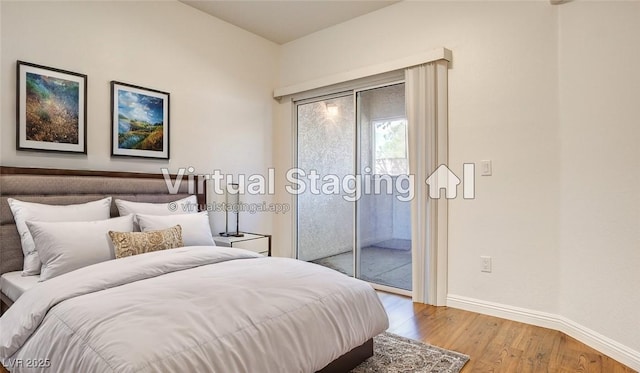 bedroom featuring access to exterior, baseboards, and wood finished floors