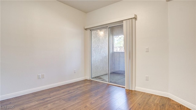 unfurnished room with wood finished floors and baseboards