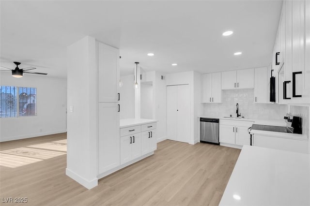 kitchen with white cabinetry, dishwasher, and light wood-type flooring