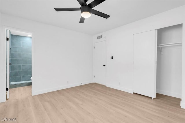 unfurnished bedroom with ceiling fan, ensuite bath, and light hardwood / wood-style flooring