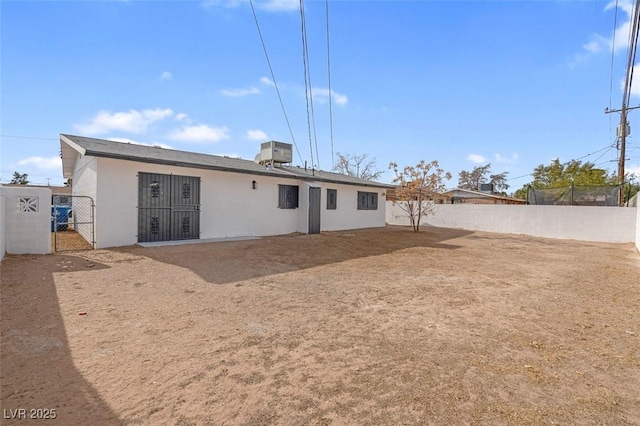 rear view of house featuring cooling unit