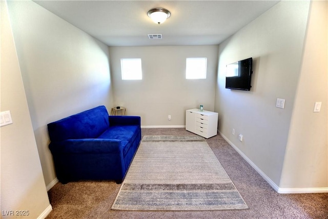 living area featuring carpet