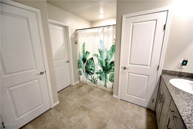 bathroom with a shower with shower curtain and vanity