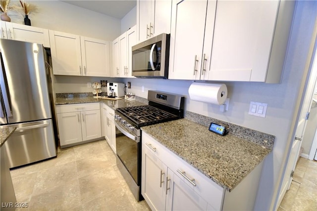 kitchen with white cabinets, stainless steel appliances, and light stone countertops