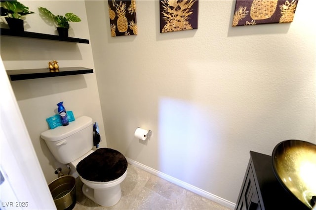 bathroom with tile patterned floors, vanity, and toilet