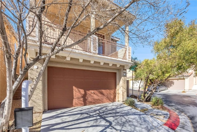 view of front of house featuring a garage and a balcony