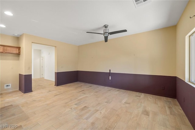 spare room featuring light wood-type flooring and ceiling fan