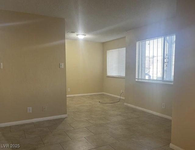 spare room featuring light tile patterned floors