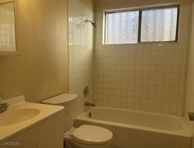 full bathroom with vanity, toilet, and tiled shower / bath