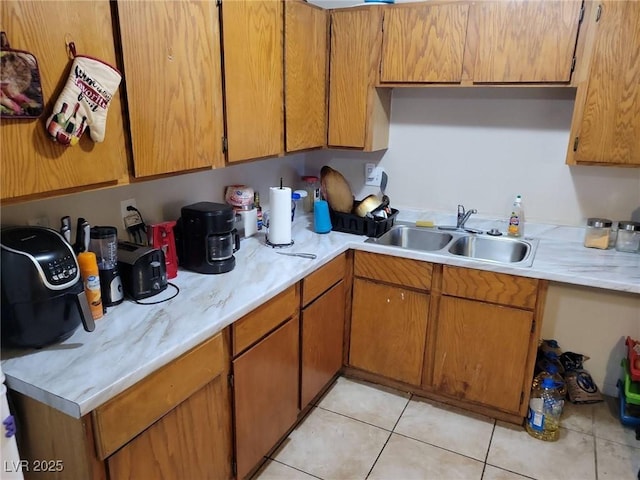 kitchen featuring light tile patterned flooring and sink