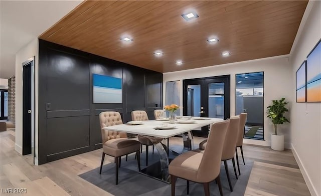 dining room with french doors, wooden ceiling, and light hardwood / wood-style flooring