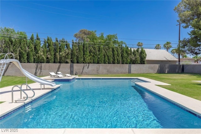 view of swimming pool featuring a water slide and a lawn