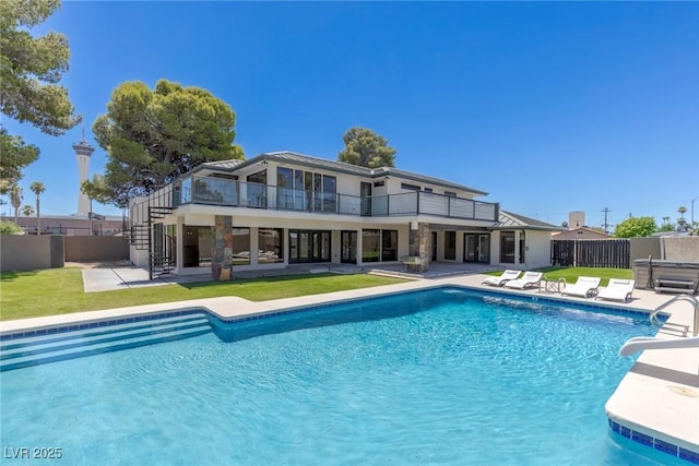 view of pool with a yard and a patio area