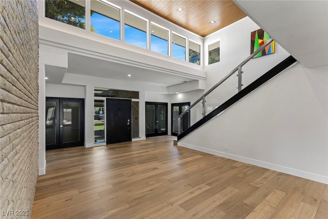 entrance foyer featuring french doors, plenty of natural light, and light wood-type flooring