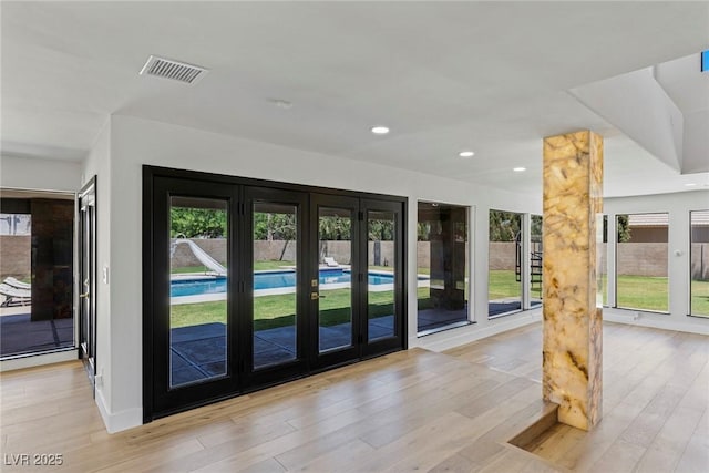 doorway to outside featuring light hardwood / wood-style floors and french doors