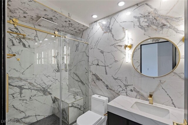 bathroom with vanity, a shower with shower door, and toilet