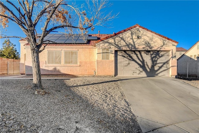 view of front of house with solar panels and a garage