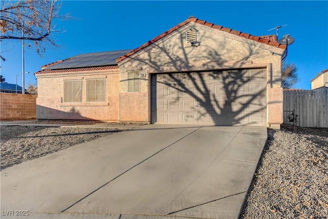 view of front of house featuring solar panels and a garage