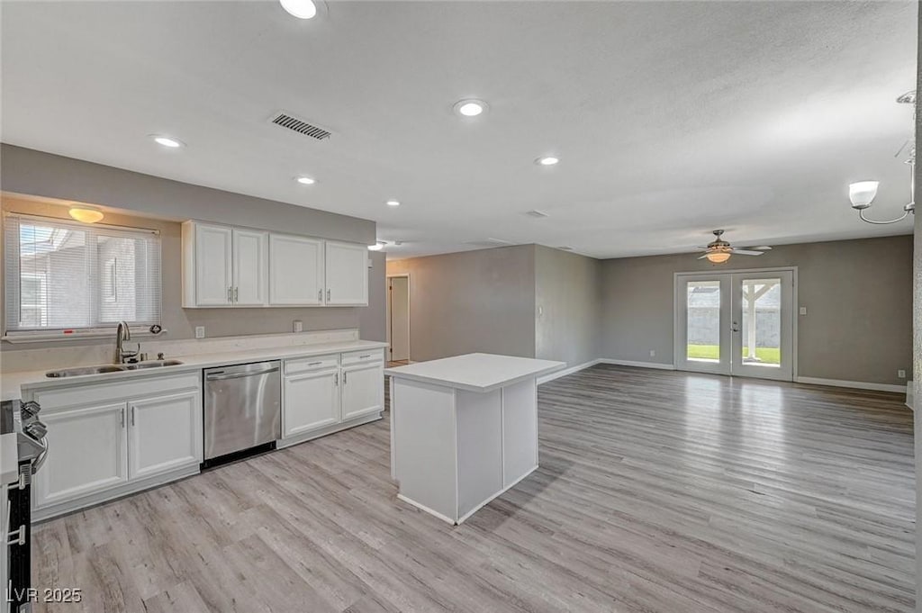 kitchen featuring appliances with stainless steel finishes, white cabinetry, a wealth of natural light, and sink