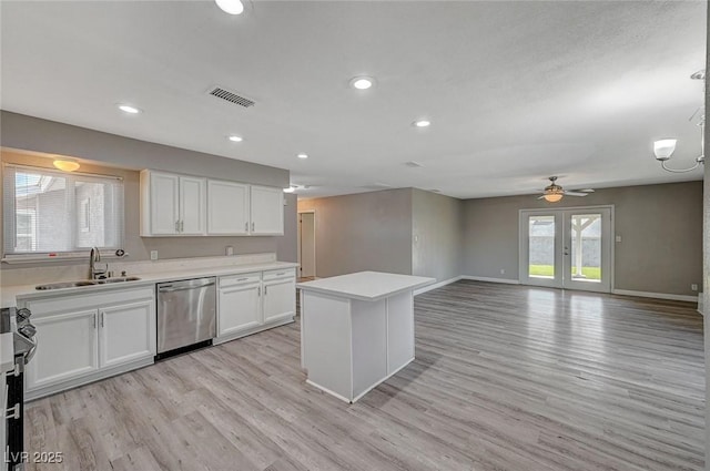 kitchen featuring appliances with stainless steel finishes, white cabinetry, a wealth of natural light, and sink