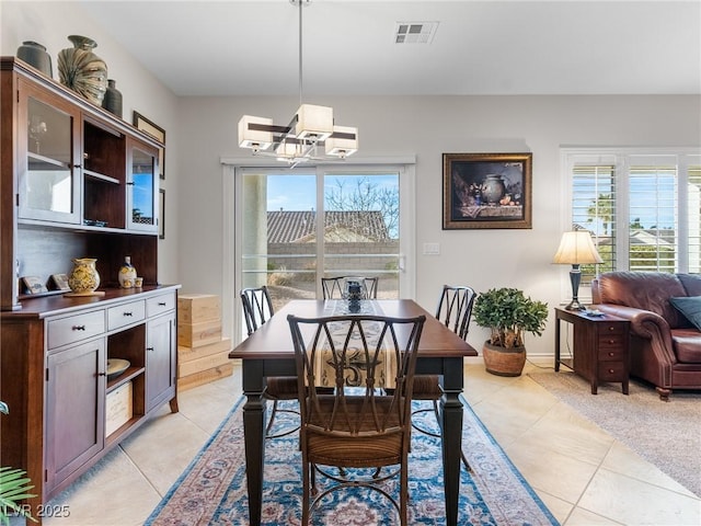 dining room featuring plenty of natural light and light tile patterned floors