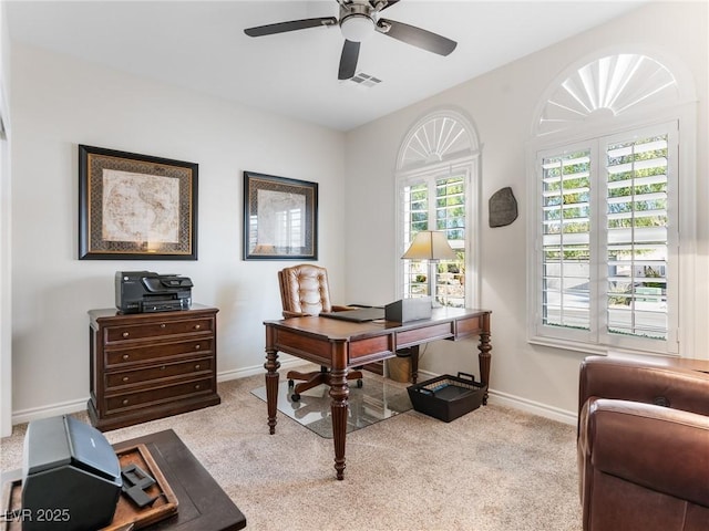 carpeted home office with ceiling fan