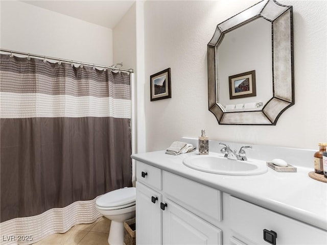 bathroom with tile patterned flooring, vanity, toilet, and walk in shower