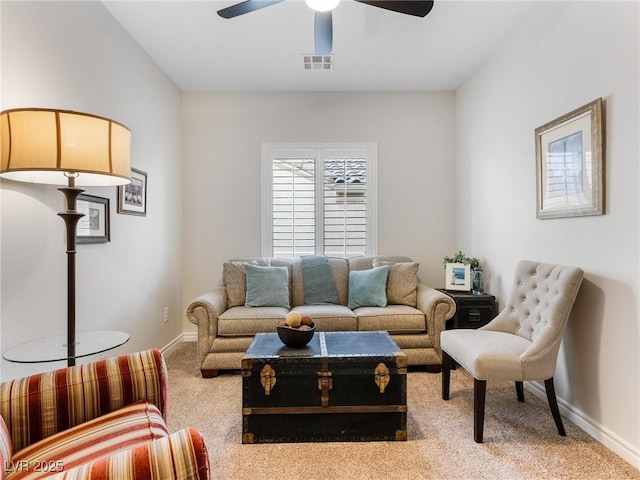 carpeted living room with ceiling fan