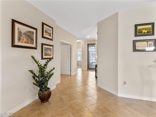 hall with light tile patterned floors