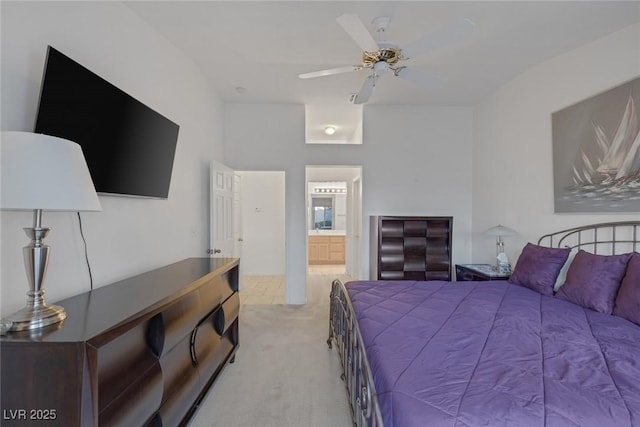 carpeted bedroom featuring ceiling fan and connected bathroom