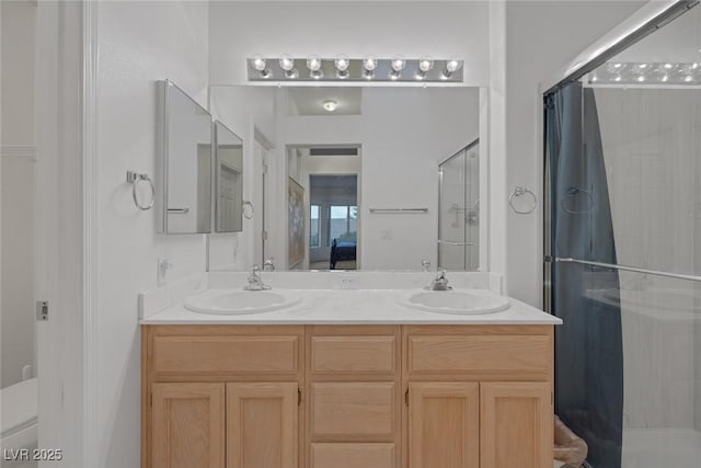 bathroom featuring an enclosed shower, vanity, and toilet