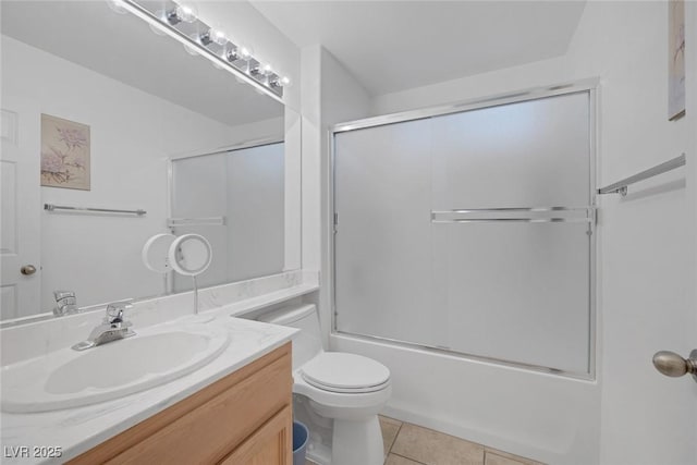 full bathroom featuring toilet, vanity, tile patterned floors, and shower / bath combination with glass door