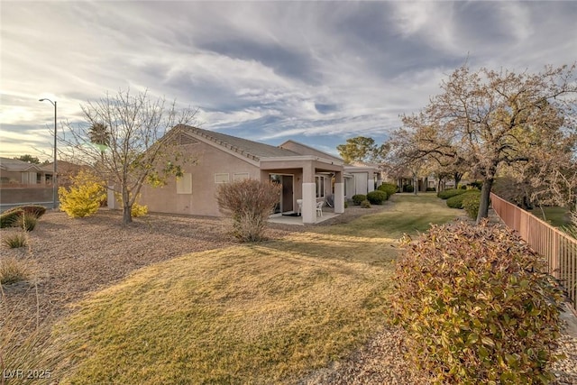 back of house featuring a patio area and a yard